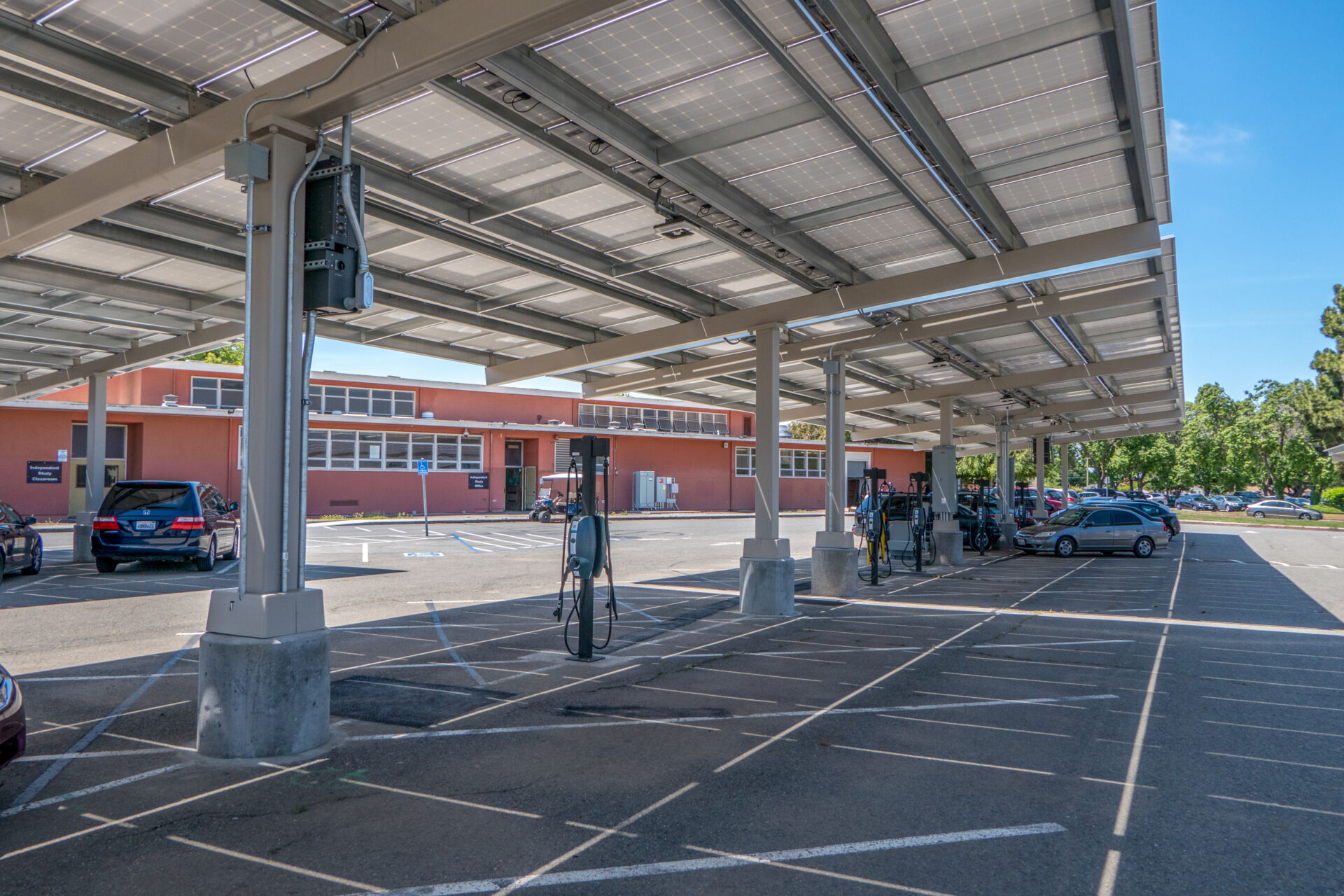 Solar panel carport with electric vehicle charging stations at a Hayward Unified School District campus following completion of energy upgrades.